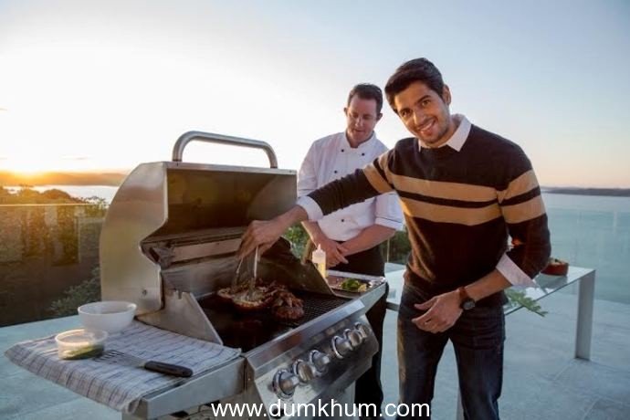 Sidharth cooking up a barbeque dinner with the head chef at Eagles Nest